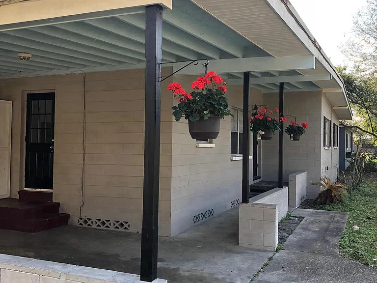 Entrance from carport on the left. Covered pathway leads to Front door on the right.