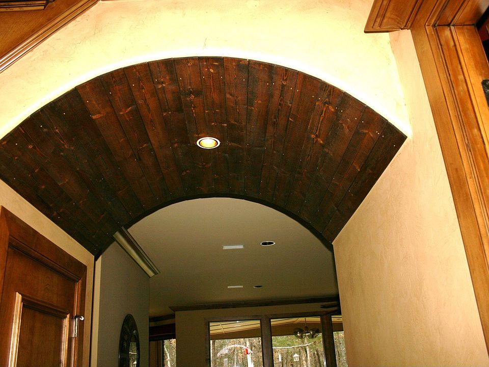 Wood barreled walk thru into entry.