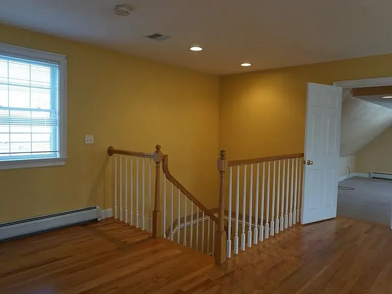 This photo show spacious landing and door to the bonus area/2nd bedroom.
This area has since been painted a more neutral color.