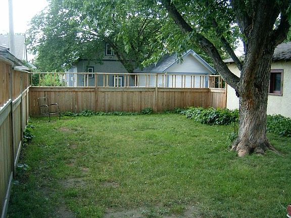 Large backyard with deck and privacy fence
