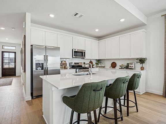 Kitchen in the Trinity home plan by Trophy Signature Homes - REPRESENTATIVE PHOTO