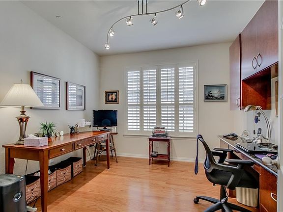 Office with french doors and built in desk/cabinets