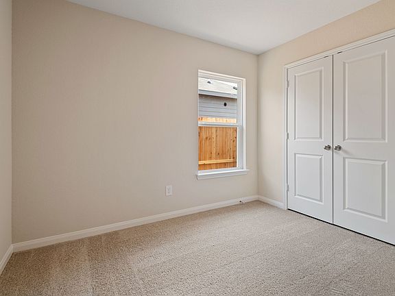 Spacious secondary bedroom with carlpet flooring