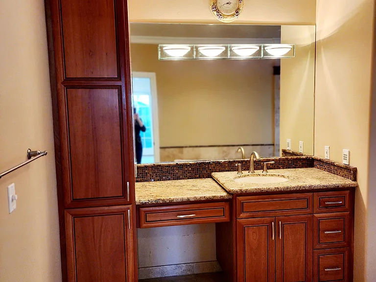 Primary bathroom with beautiful custom tile, cabinets &vanity.