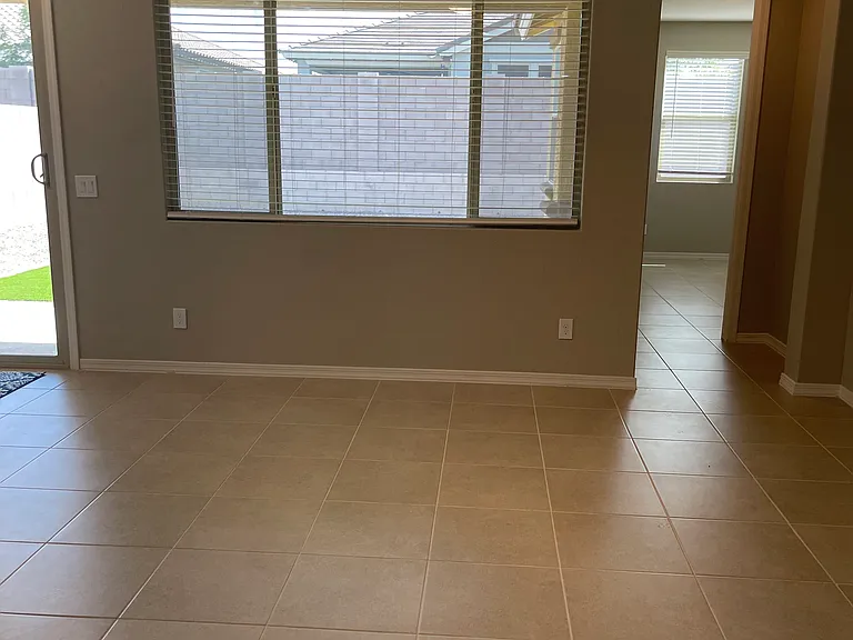 Another view of living area with arched hallway to master bedroom.