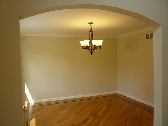 Formal DR with Border Detail hardwood and arch doorways