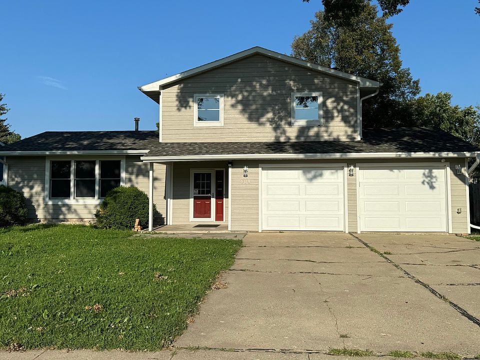 Front view shows living room on left entry and extra large garage and two of the bedrooms upstairs..