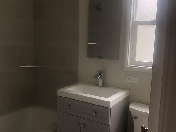 New shower tile, vanity, mirror and lighting.