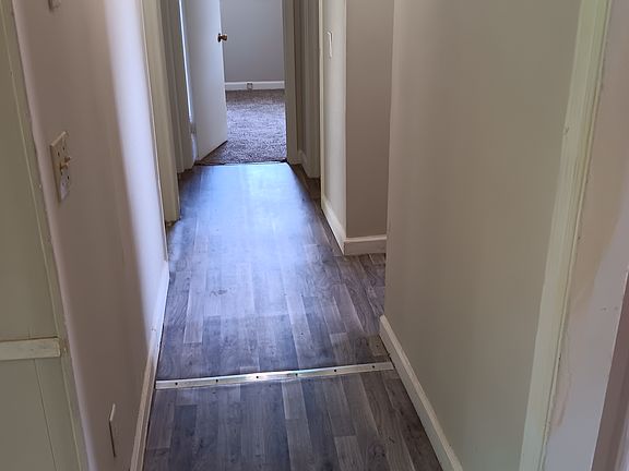 Hall leads to 3 bedrooms, full bath and the 1/2 bath that also has access from owners bedroom. New floors.