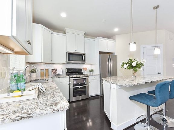 Modern kitchen with stainless appliances and generous cabinet storage
