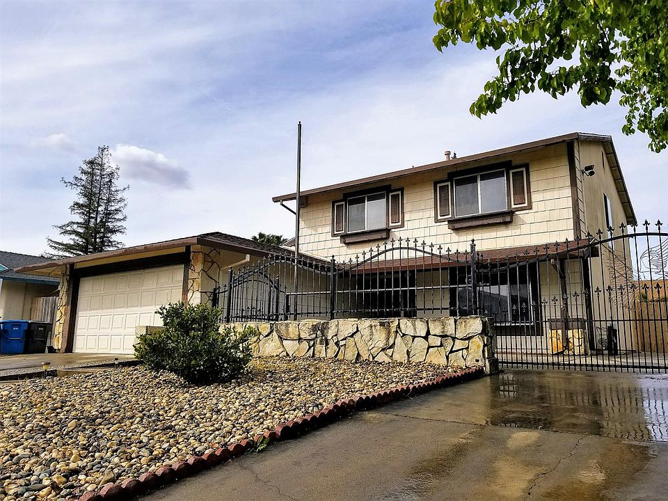 Front with rock accents and gated courtyard