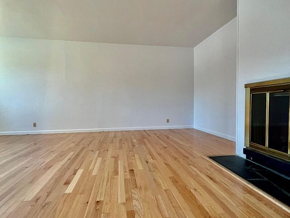 A spacious living room and fireplace