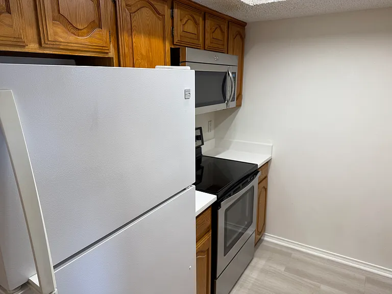 Updated microwave and drop in range and oven. Includes refriderator.