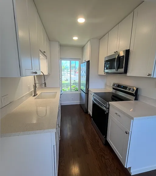 The kitchen has plenty of space with a ceiling-to-floor food pantry.