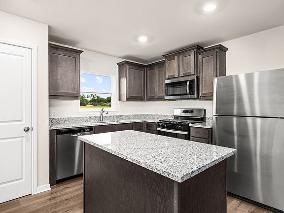 The kitchen has beautiful wood cabinetry.