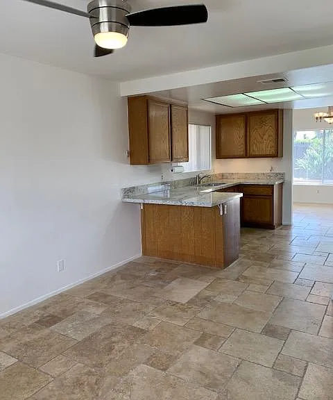 Kitchen offers granite counter tops and stone flooring