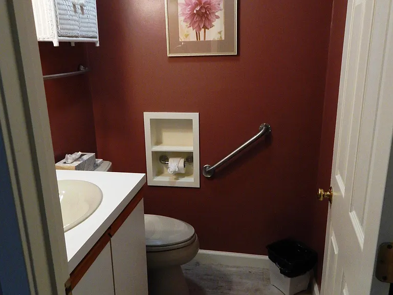 1st floor half bath. Porcelain floor tile & in-floor radiant heat with a programmable thermostat. Comfort height toilet & vanity, grab bar