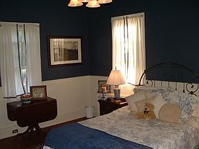This bedroom is light and airey with four beautiful windows.