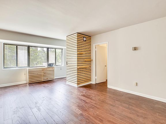 Sunny studio with wall of windows, new wood floors and wood accents