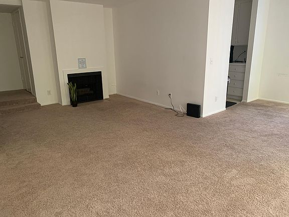 Living Room, Fireplace, Dining Room area to the far right and entryway to the Kitchen.