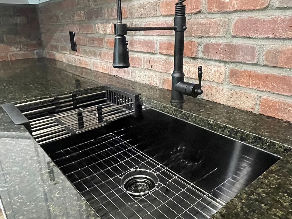 Granite countertops, clean black stainless under-mount sinks, farmhouse faucet