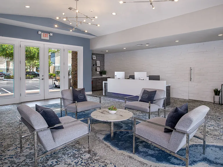 Step into comfort at the Harper Grand clubhousefeaturing modern seating, a welcoming atmosphere, and a sleek leasing center designed for your convenience.