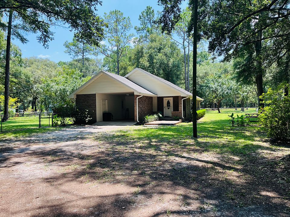 Private driveway with gate, leading up to home.