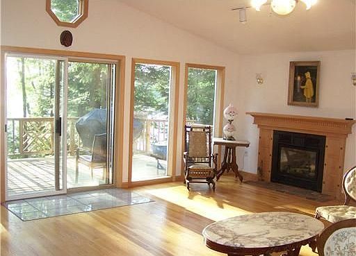 sun filled living room with gas fireplace 