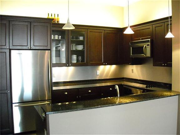 All stainless kitchen with cool lighting.