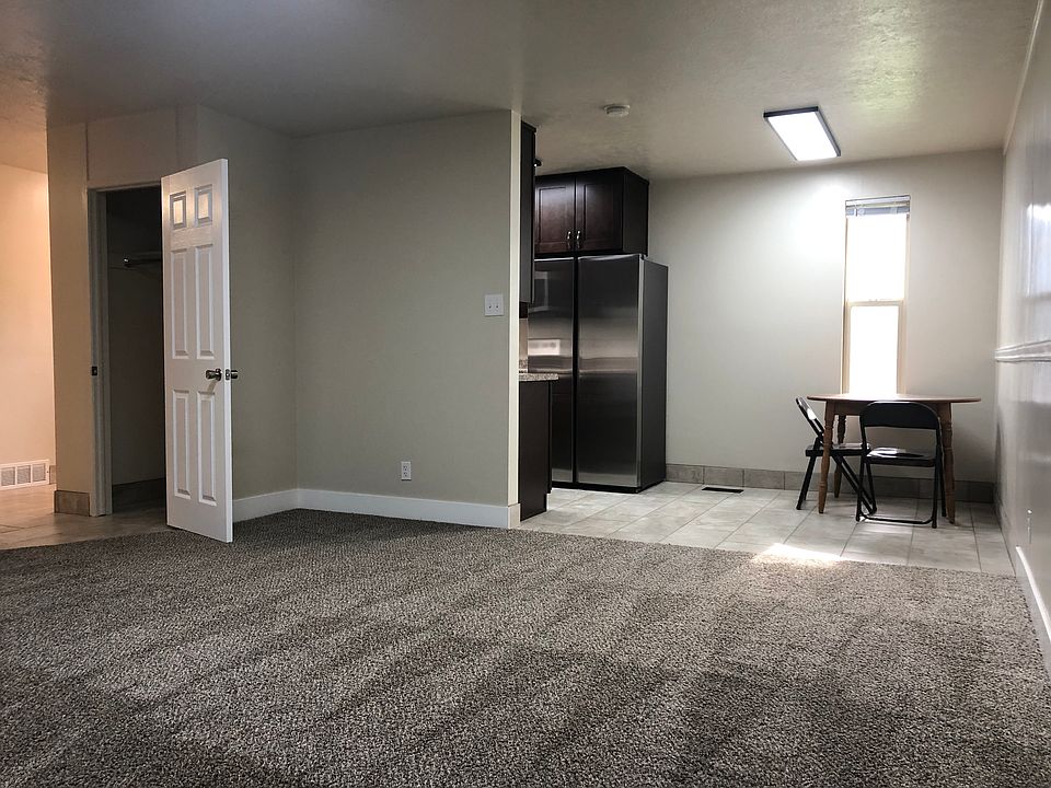 Standing at the back door looking through the family room in to the dining room/kitchen and hall way/entry way showing the open coat closet.