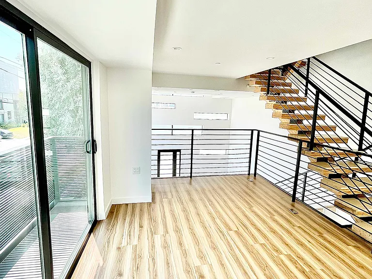 Mezzanine with balcony. Flex space overlooking living room. Very functional space perfect for a home office