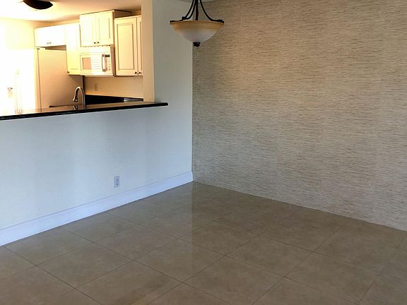 Dining area and higher countertop for sitting area looking at kitchen