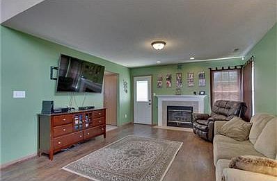 Newer flooring in the living room, gas log fireplace for cozy evenings.