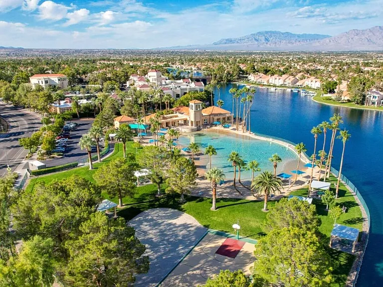view from drone, you overlook the lake, beach, and volleyball court directly from house
