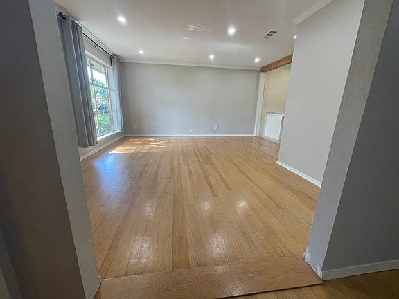 Open floor plan living space with beautiful hardwood floors.