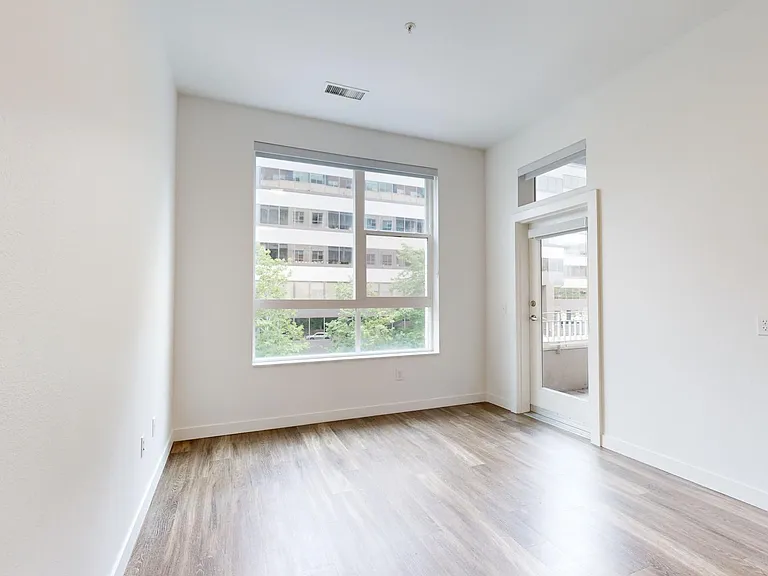 Apartment living room with wood-style flooring.