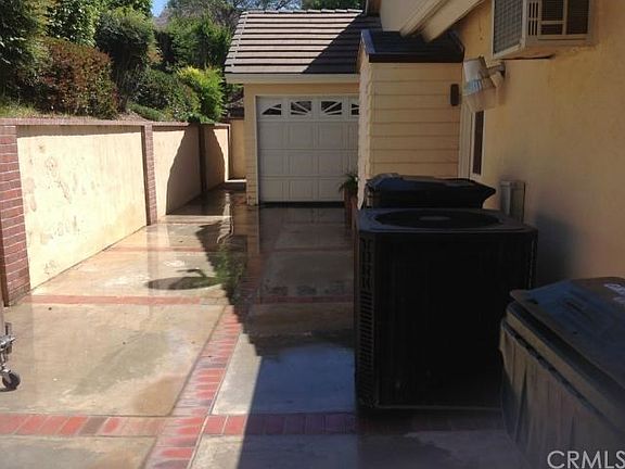 Separate from the garage is a workshop with roll up single door and 220v outlet, insulated walls and an air conditioning unit