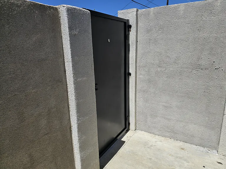 Private outdoor area with private entrance from alley.