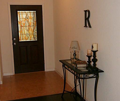 Wonderful entry features a lovely wood stained glass front door along with a storm door with security features