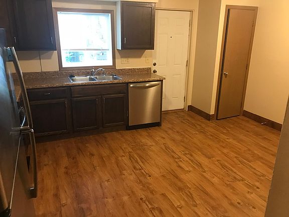 Large kitchen with room for dining room table, exterior entrance to parking lot