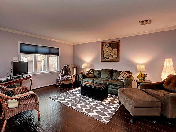 The family room looks out to the patio through a big replaced window. It opens to the dining area and the kitchen. The floors ar