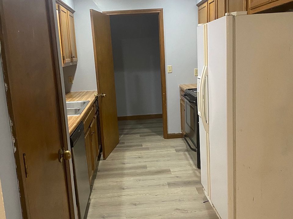 Kitchen leading into laundry. Includes pantry, dishwasher, stove, new microwave, refrigerator