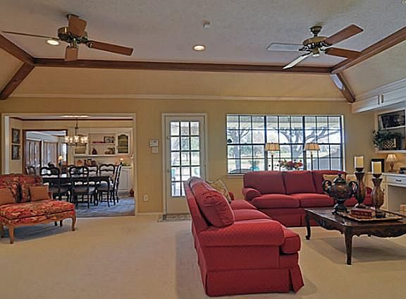 Living Room features Masonry Fireplace with Built-ins and Beamed Ceiling!