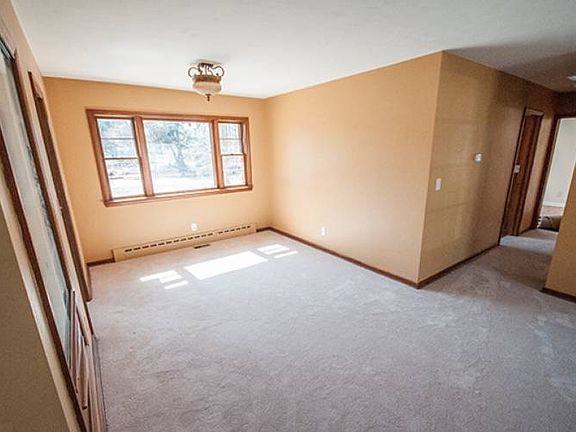 Natural light flows through the dining room (11x9) which connects the kitchen to the living room with bedrooms down the hall.