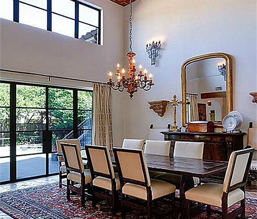 (19x16) The dining room features a double-height wood-plank and beamed ceiling painted with Moorish arabesque designs. Note steel-framed windows and doors.