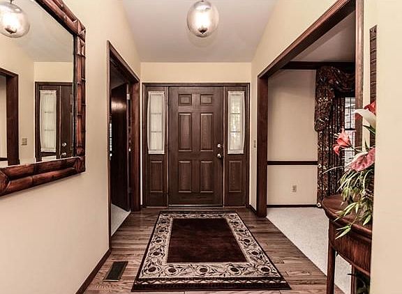 Entry foyer with wood flooring.