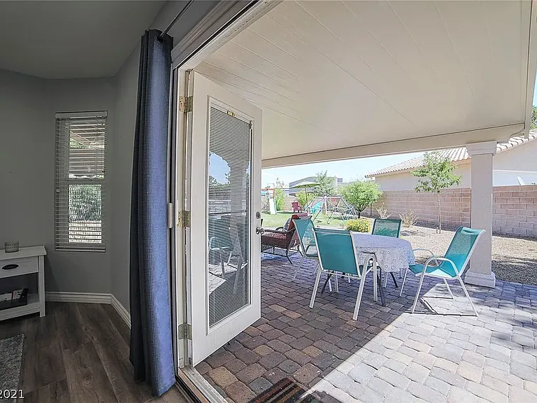 French doors in primary suite open to patio.