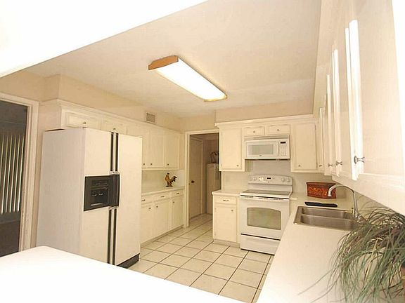 Step saving kitchen with refrigerator included.