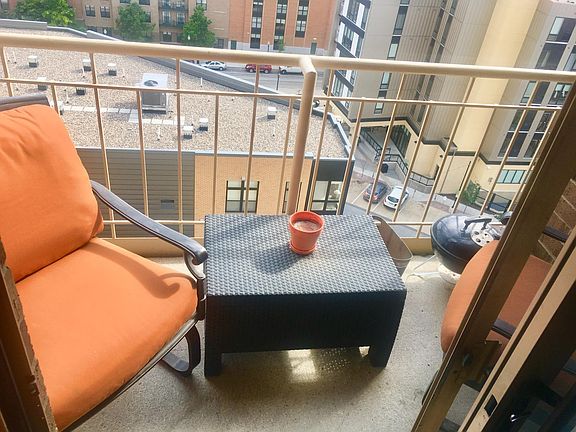 Balcony area with chairs & grill