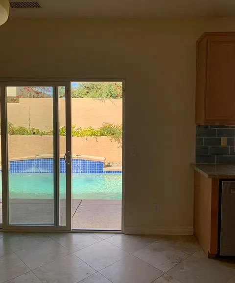 Slider out to pool from dining area by kitchen.